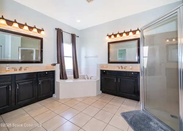 a spacious bathroom with a sink a mirror and a bathtub