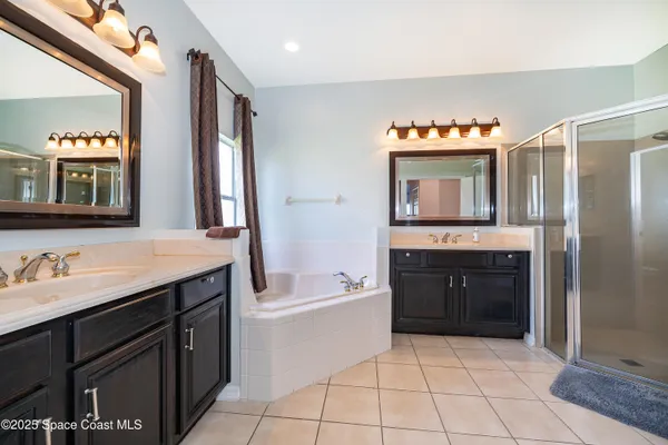 a spacious bathroom with a bathtub sink and a mirror