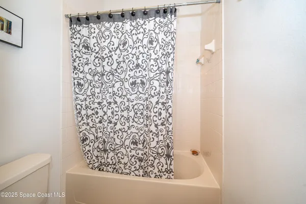 a bathroom with a bathtub and shower