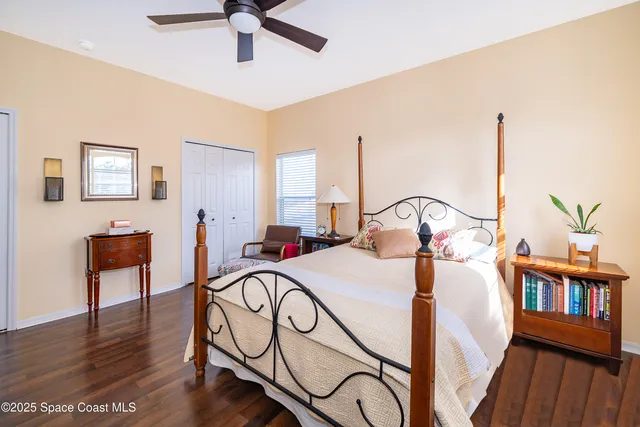 a bedroom with a bed and flat screen tv