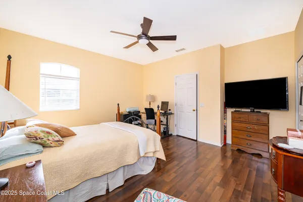 a bedroom with a bed and flat screen tv