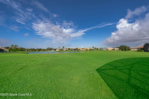 a view of yard with island and trees in the background