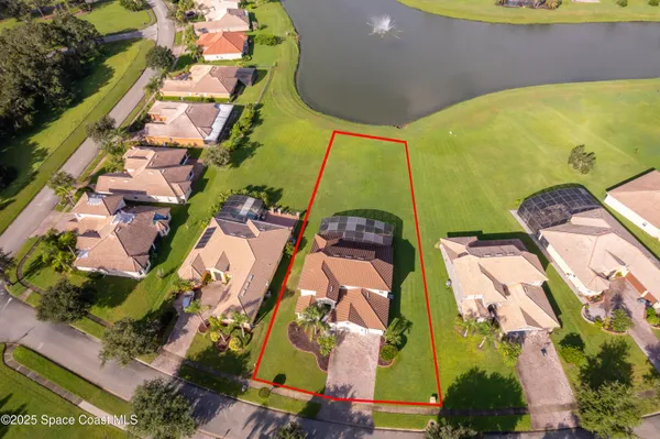 an aerial view of a house with a swimming pool