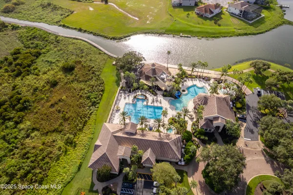an aerial view of a house with a yard and lake view
