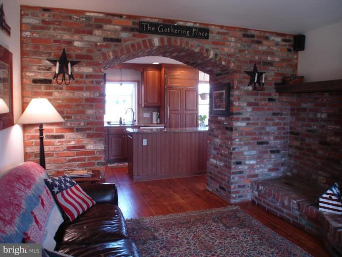 1912 Wilson Road White Hall, MD 21161 - Photo 11 of 29 a living room with furniture a lamp and a fireplace