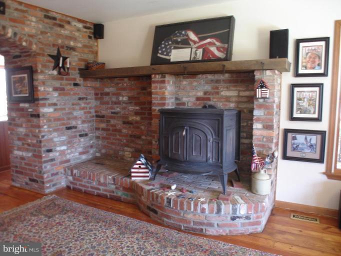 1912 Wilson Road White Hall, MD 21161 - Photo 12 of 29 a view of a fireplace with wooden floor