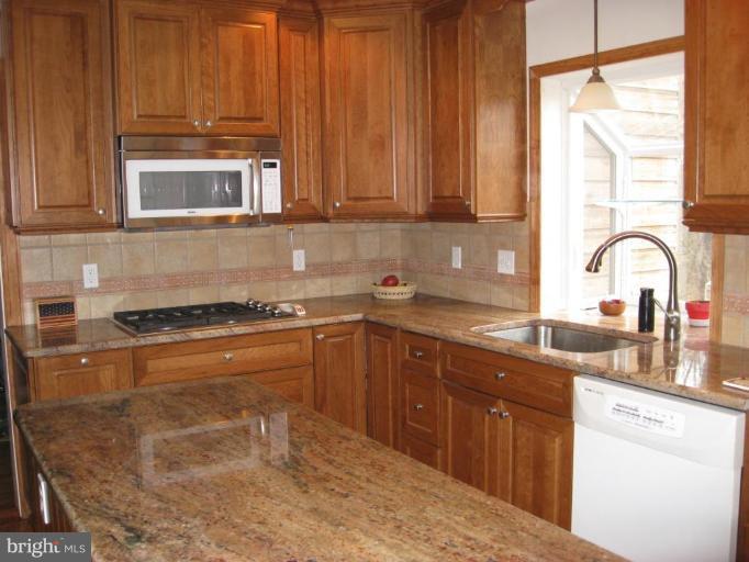 1912 Wilson Road White Hall, MD 21161 - Photo 17 of 29 a kitchen with stainless steel appliances granite countertop a stove a sink and a microwave