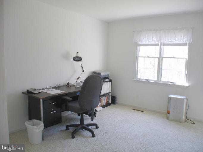 1912 Wilson Road White Hall, MD 21161 - Photo 4 of 29 a view of a workspace with furniture and a window