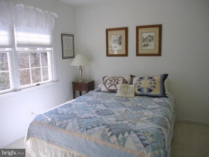 1912 Wilson Road White Hall, MD 21161 - Photo 5 of 29 a large bed sitting in a bedroom next to a window