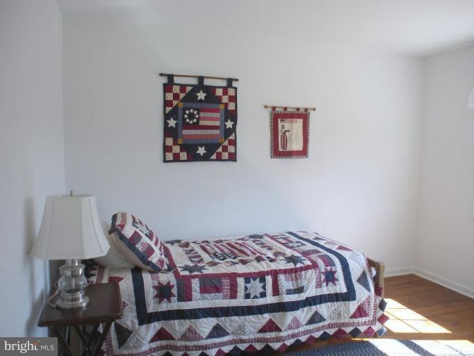1912 Wilson Road White Hall, MD 21161 - Photo 6 of 29 a bedroom with a bed and a lamp
