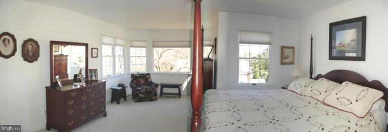 1912 Wilson Road White Hall, MD 21161 - Photo 8 of 29 a bedroom with a bed and large windows