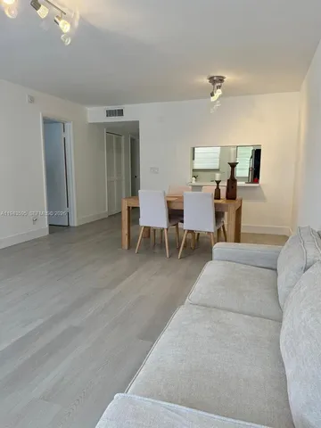 a living room with furniture and a dining table