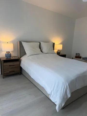 a bedroom with a bed and lamp