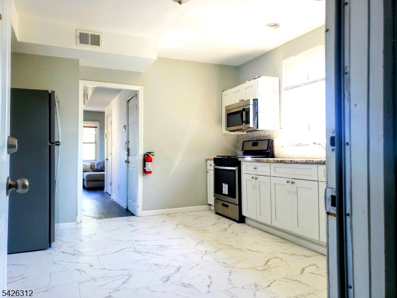 215 Lafayette Street Orange, NJ 07050 - Photo 13 of 14 a view of a kitchen with a sink and dishwasher kitchen view