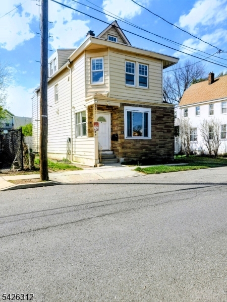 215 Lafayette Street Orange, NJ 07050 - Photo 2 of 14 a front view of a house with a yard
