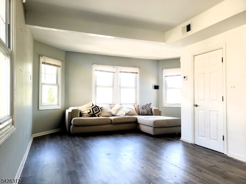 215 Lafayette Street Orange, NJ 07050 - Photo 3 of 14 a living room with furniture and a wooden floor