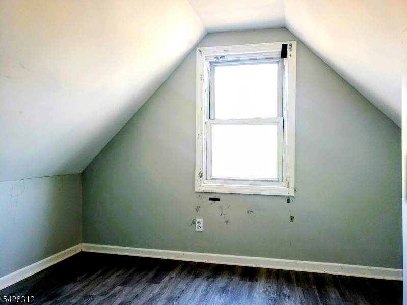 215 Lafayette Street Orange, NJ 07050 - Photo 7 of 14 an empty room with wooden floor and a window