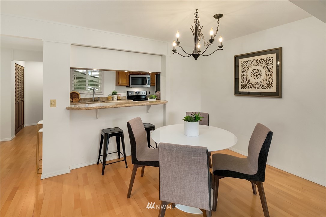 7577 Old Redmond Road, Unit 11 Redmond, WA 98052 - Photo 8 of 19 a view of a dining room with furniture a chandelier and wooden floor