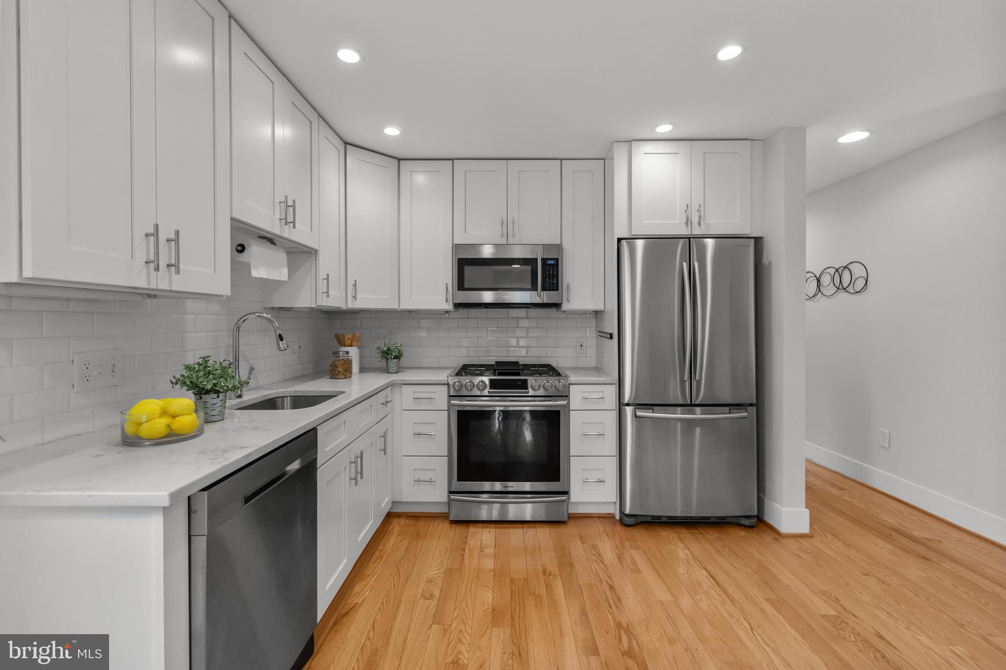 1627 Holbrook Street Northeast, Unit 2 Washington, DC 20002 - Photo 7 of 24 a kitchen with a refrigerator and a stove top oven