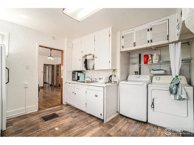 a utility room with cabinets washer and dryer