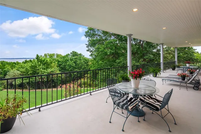 a view of a patio with a table chairs and a backyard