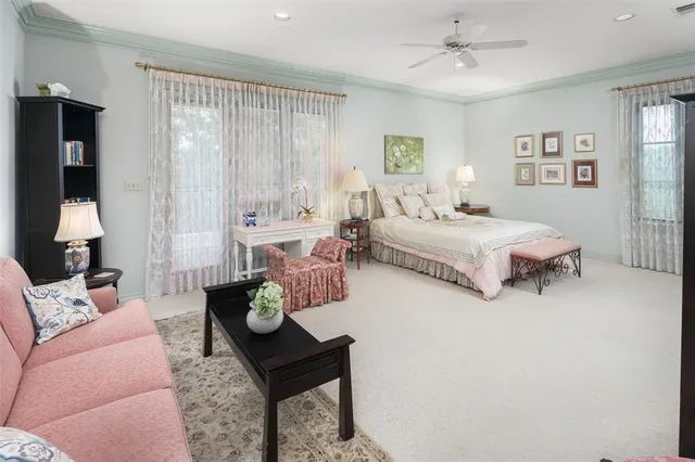 a spacious bedroom with a bed a couch and dresser