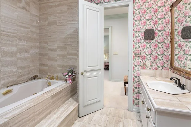 a bathroom with a tub sink and mirror