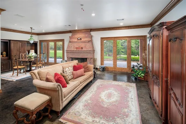 a living room with furniture fireplace and a large window