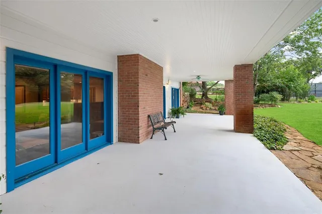 a view of a patio with a table and chairs
