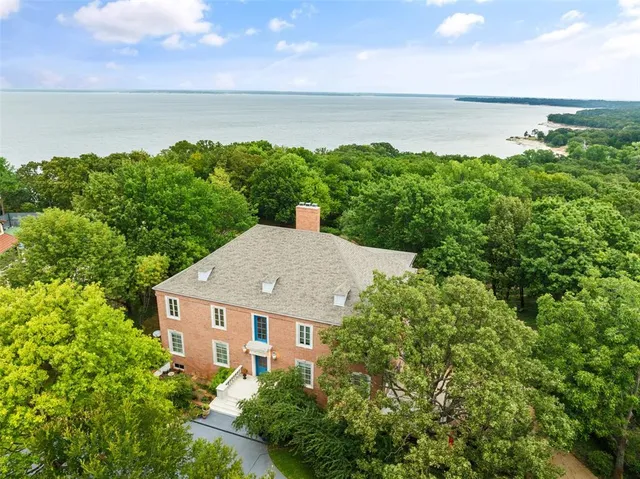 a aerial view of a house with lake and outdoor space