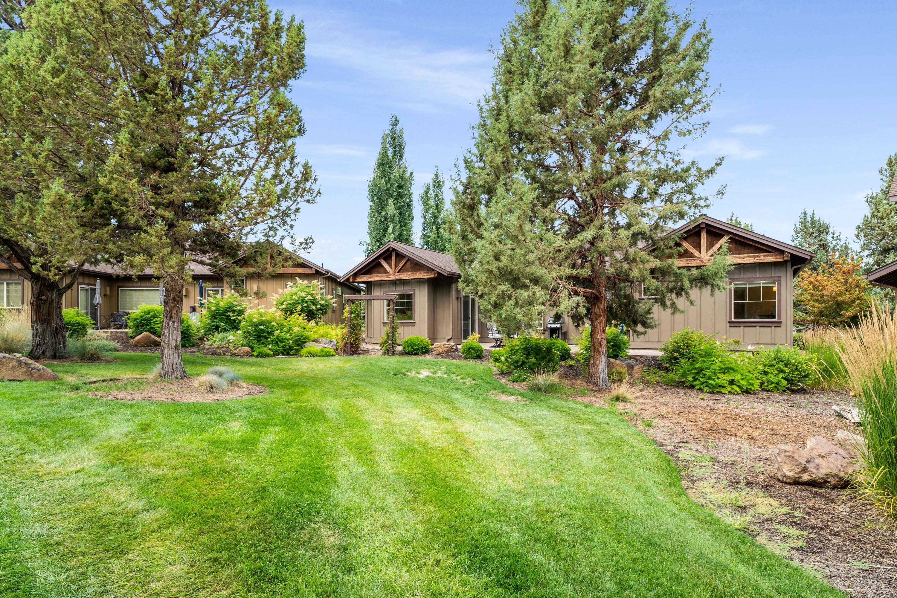 205 Vista Rim Drive Redmond, OR 97756 - Photo 34 of 85 a front view of a house with a yard and trees