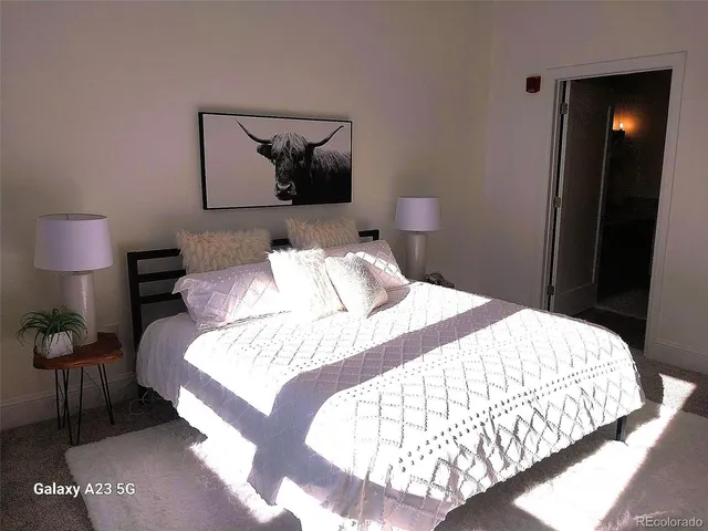 a bedroom with a bed and a chair