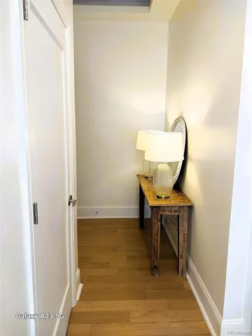 a living room with furniture floor to ceiling window and wooden floor