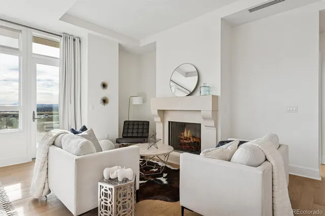 a living room with furniture a fireplace and a wooden floor