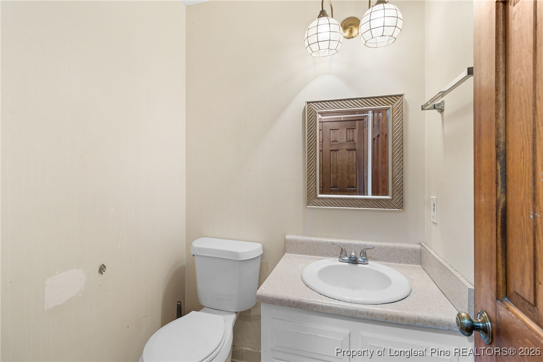 2924 Walden Road Fayetteville, NC 28303 - Photo 18 of 44 a bathroom with a granite countertop toilet and a sink