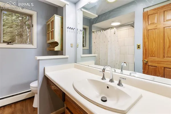 a bathroom with a sink a mirror and a window