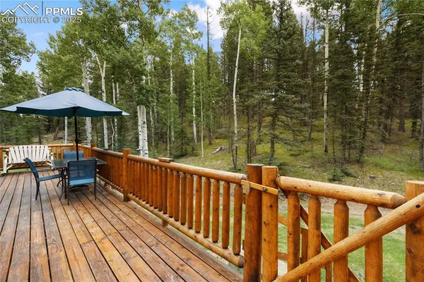 a view of a wooden deck with furniture