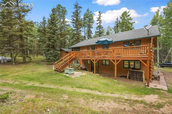 a view of a house with a yard balcony and slide