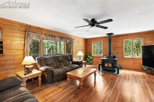 a living room with furniture tv and a large window