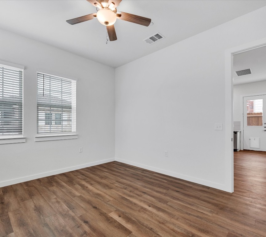 2703-406 Rockhill Road McKinney, TX 75072 - Photo 9 of 14 an empty room with wooden floor chandelier fan and windows