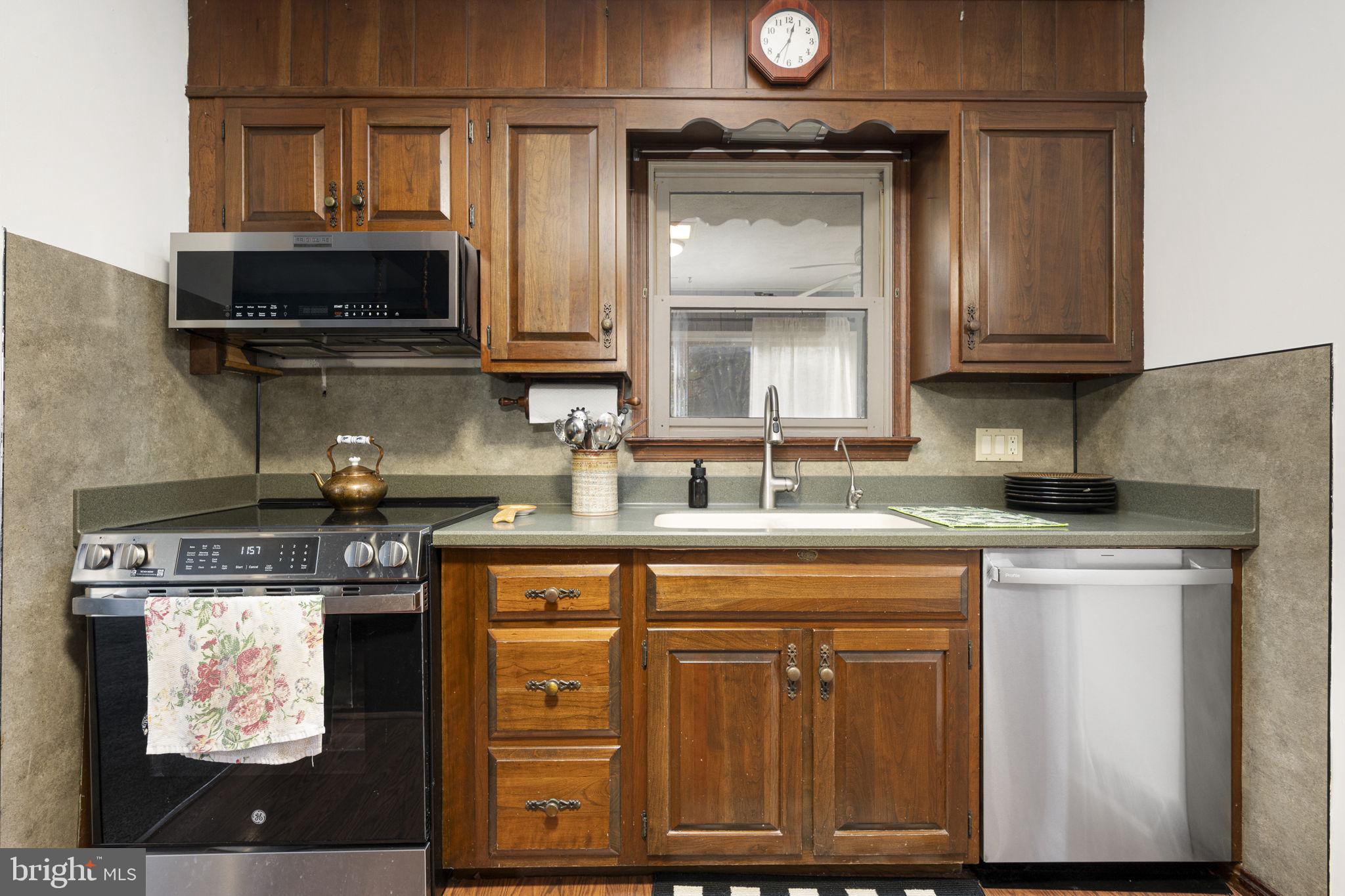 46 Green Acre Road Lititz, PA 17543 - Photo 11 of 44 a kitchen with stainless steel appliances granite countertop a stove a sink and a microwave