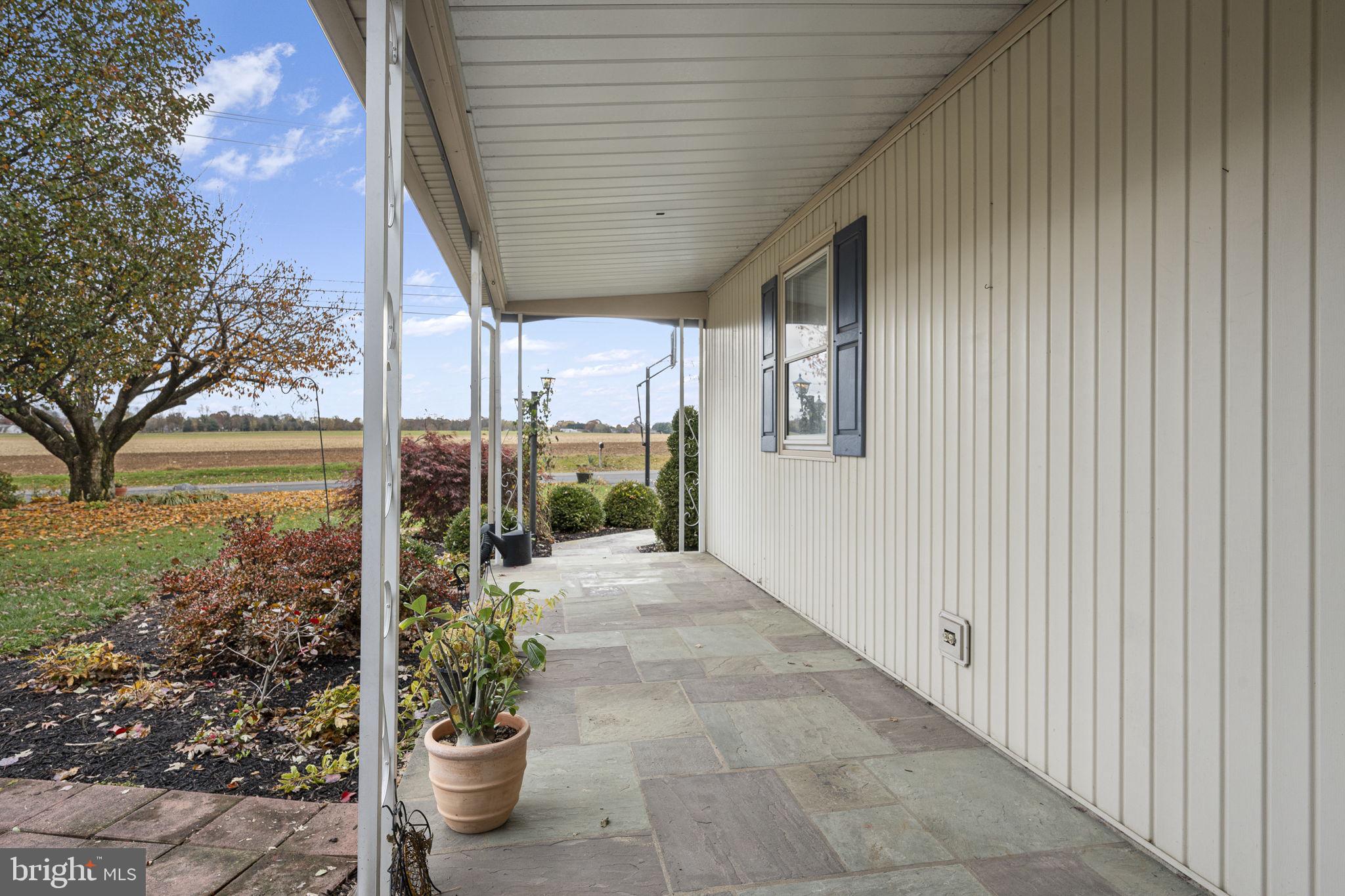 46 Green Acre Road Lititz, PA 17543 - Photo 3 of 44 a porch with a table and chairs and potted plants