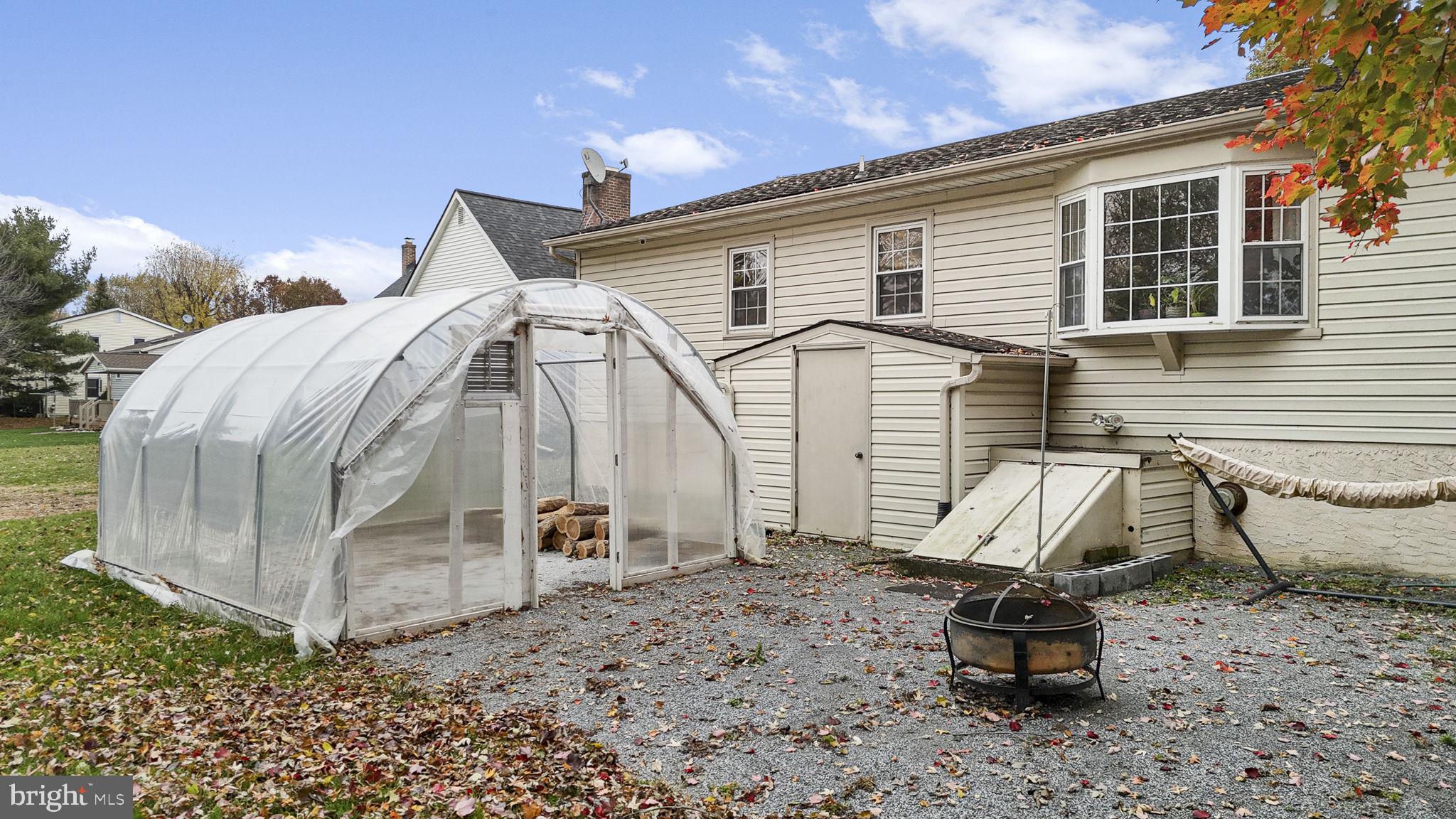 46 Green Acre Road Lititz, PA 17543 - Photo 37 of 44 a white building with a bench next to yard