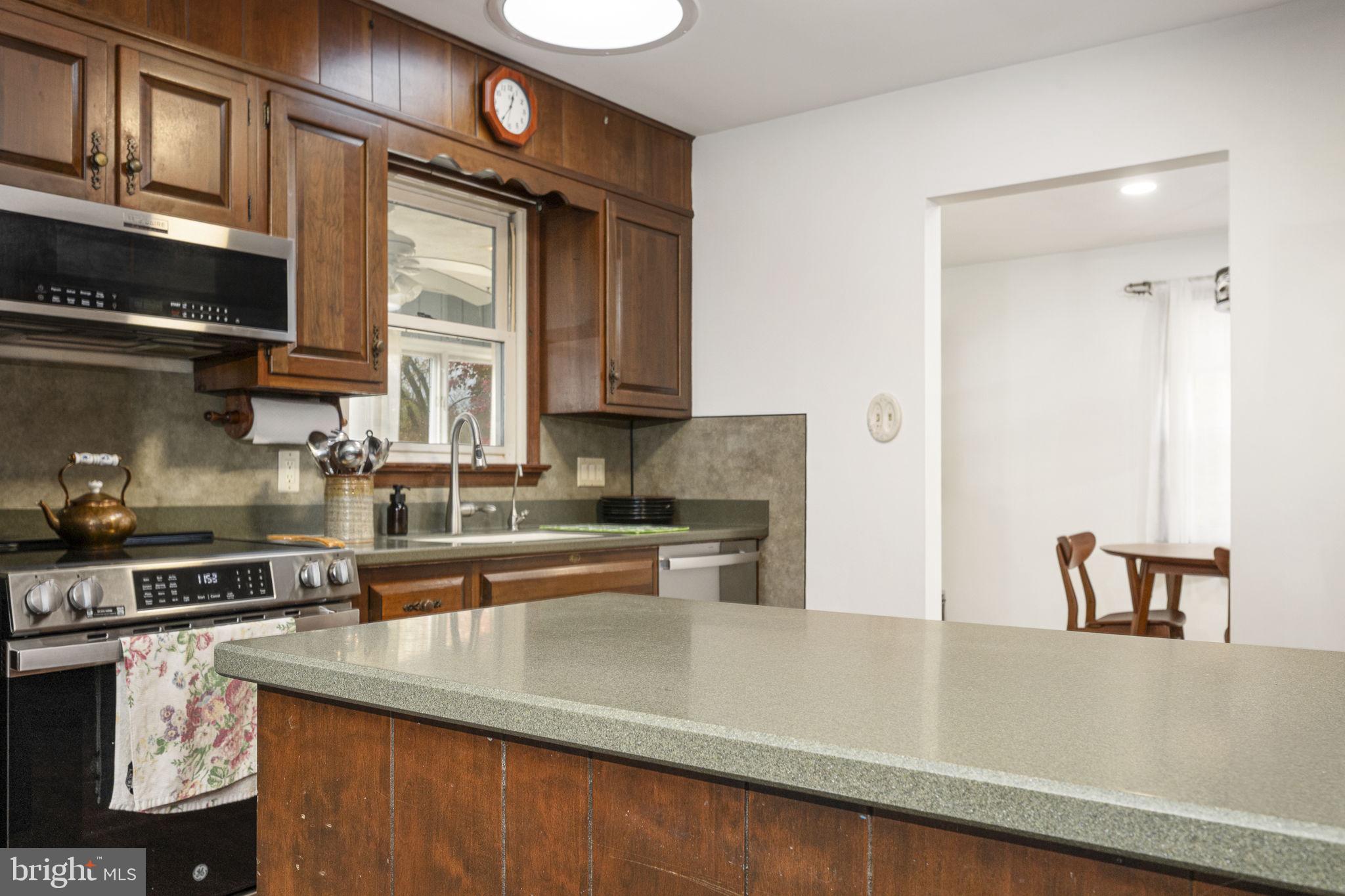 46 Green Acre Road Lititz, PA 17543 - Photo 10 of 44 a kitchen with stainless steel appliances granite countertop a sink a stove and a wooden cabinets