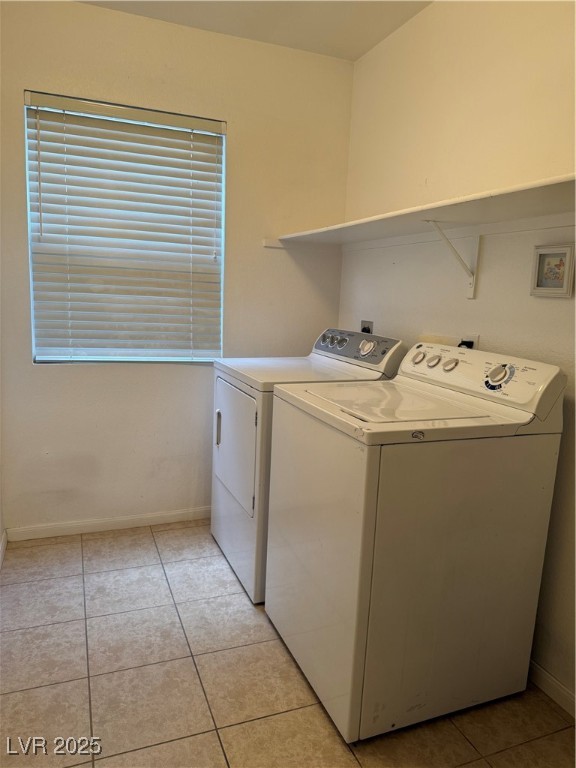 2733 Chokecherry Avenue Henderson, NV 89074 - Photo 12 of 26 Laundry room with light tile patterned floors and washer and clothes dryer