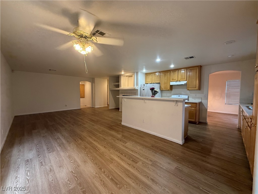 2733 Chokecherry Avenue Henderson, NV 89074 - Photo 26 of 26 Kitchen featuring arched walkways, light countertops, white appliances, open floor plan, and ceiling fan