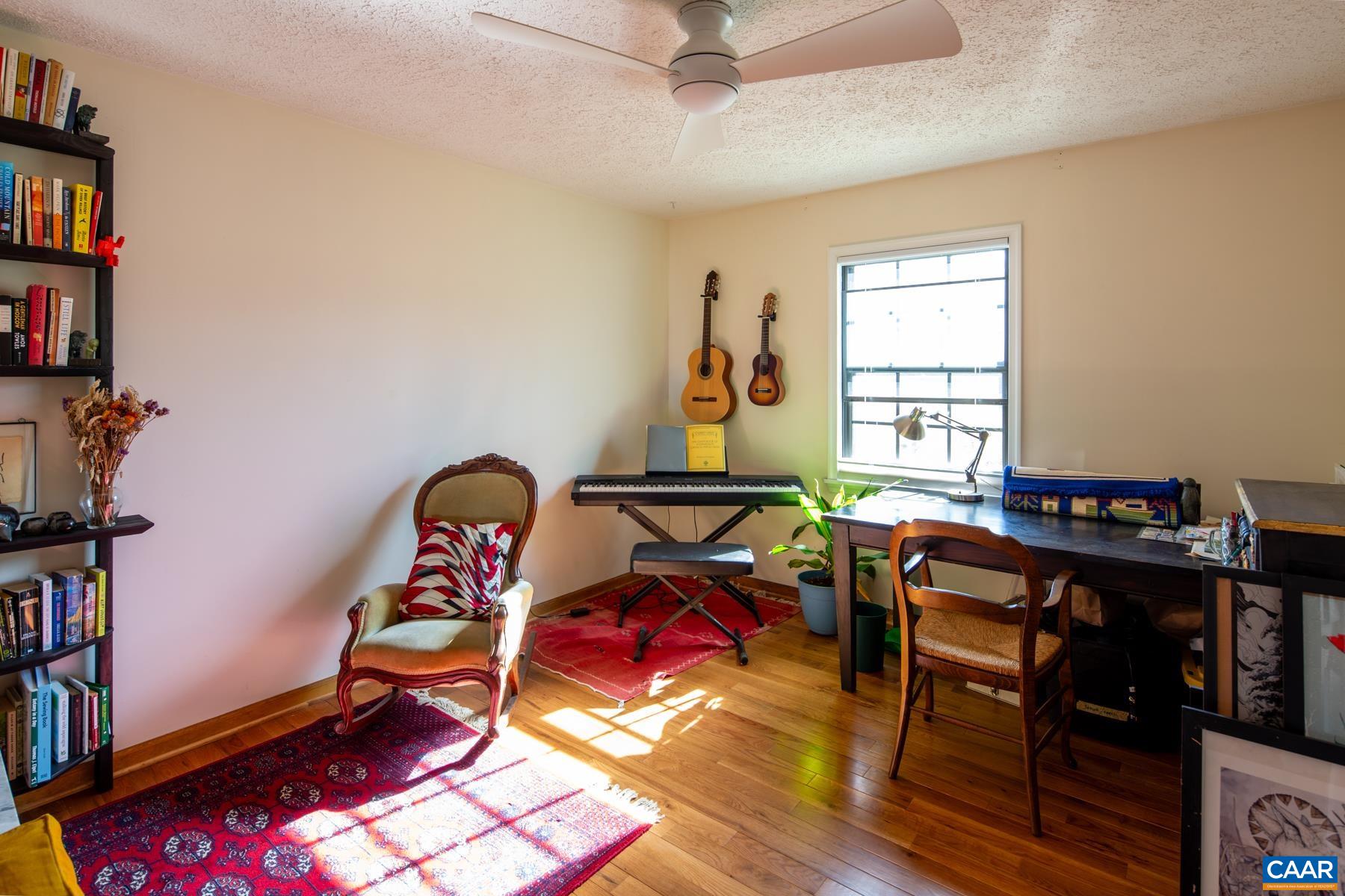 150 Buckingham Circle Charlottesville, VA 22903 - Photo 17 of 27 a living room with furniture a bookshelf and a window
