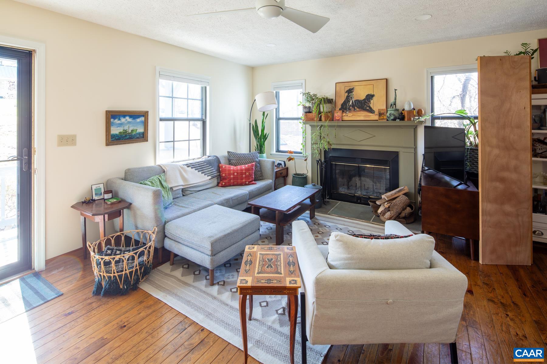 150 Buckingham Circle Charlottesville, VA 22903 - Photo 4 of 27 a living room with furniture and a fireplace