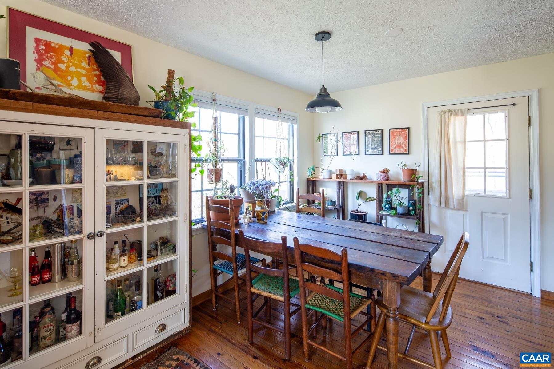 150 Buckingham Circle Charlottesville, VA 22903 - Photo 6 of 27 a view of a dining room with furniture window and wooden floor