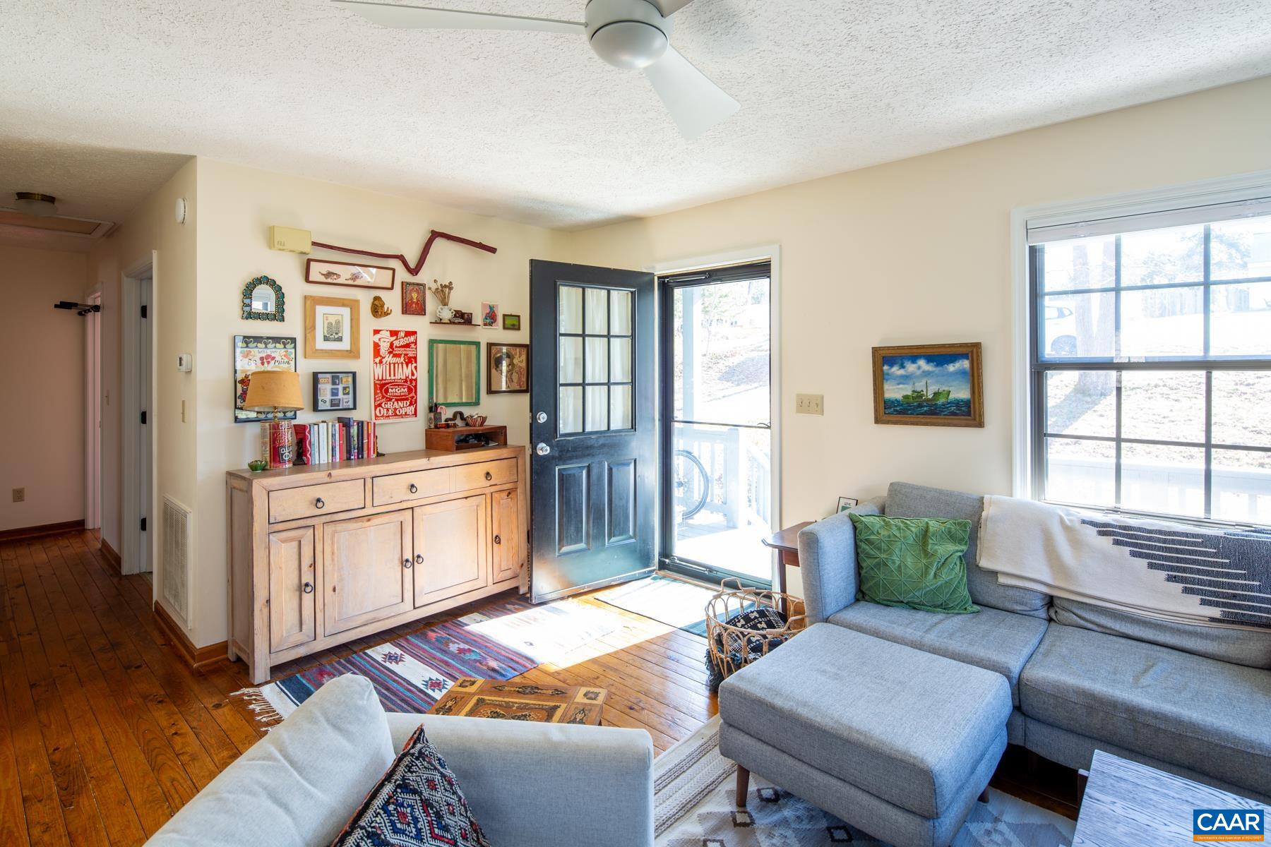 150 Buckingham Circle Charlottesville, VA 22903 - Photo 8 of 27 a living room with furniture a window and a bookshelf